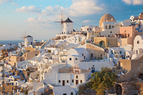 SANTORINI, GREECE - OCTOBER 4, 2015: The look to part of Oia with the windmills in evening light.