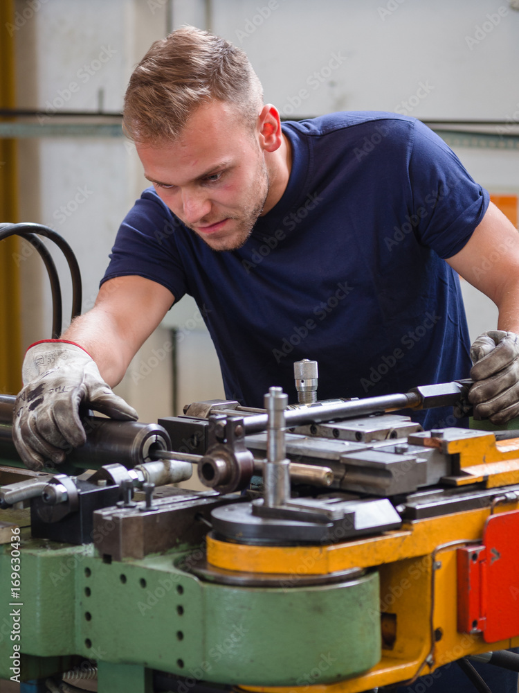 Maintenance work on a bending machine in a workshop. Maintenance work on a bending machine in a workshop.
