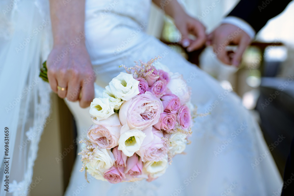 Beautiful bride is holding a wedding colorful bouquet Beautiful bride is holding a wedding colorful bouquet
