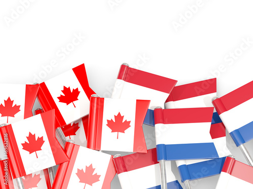 Flag pins of Canada and Netherlands isolated on white