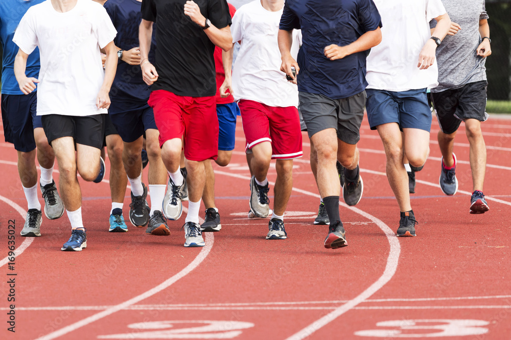 Group of high school boys running on a track