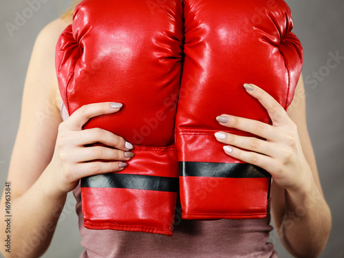 Woman holding red boxing gloves