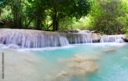 Waterfall in the jungle with lush greenery in the rainy season. © Sky Stock