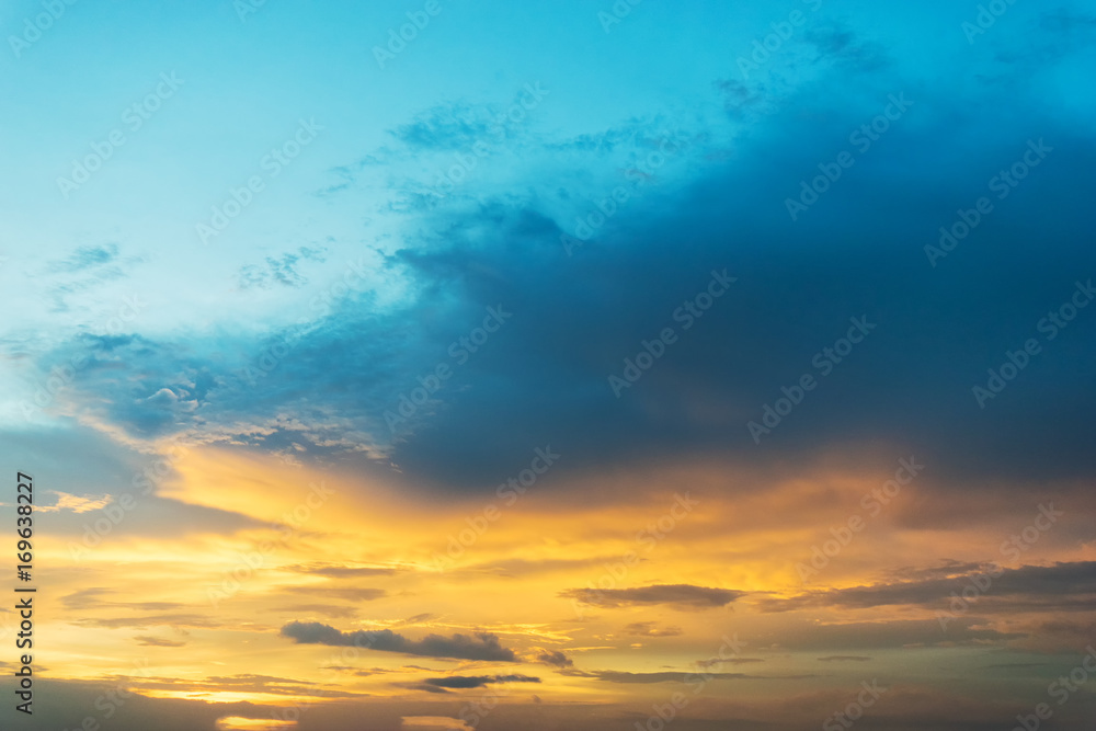 Sky background at sunset,Sky blue and orange light of the sun through the clouds in the sky survive