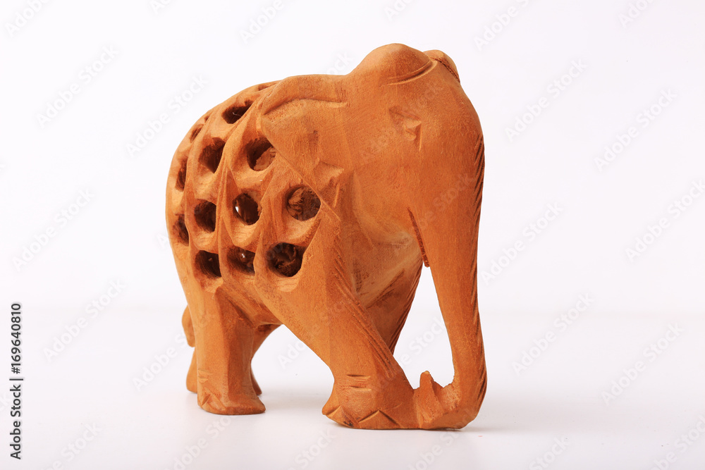 Fototapeta premium Wooden handmade statuette of elephant a white background
