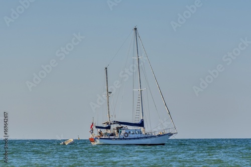 Classic white yachts anchored in the port . Sailing a classic yacht on the Black Sea.Vintage sailboat anchored in turquoise water .