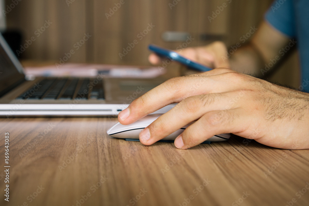 left handed person holding a mouse. left handed person holding a mouse.