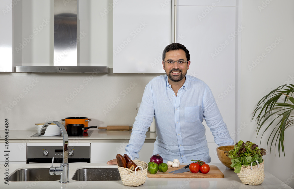 arab man preparing food in his urban apartment arab man preparing food in his urban apartment