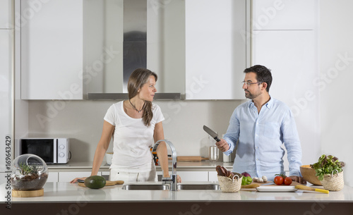 couple preparing food in a kitchen