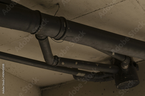 Apparent pipes on concrete ceiling.