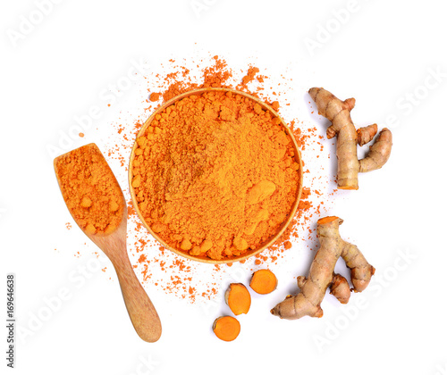 top view of turmeric roots and turmeric powder in wooden bowl isolated on white background