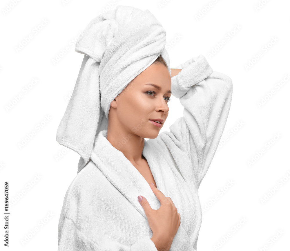 Beautiful young woman in bathrobe after shower on white background Beautiful young woman in bathrobe after shower on white background