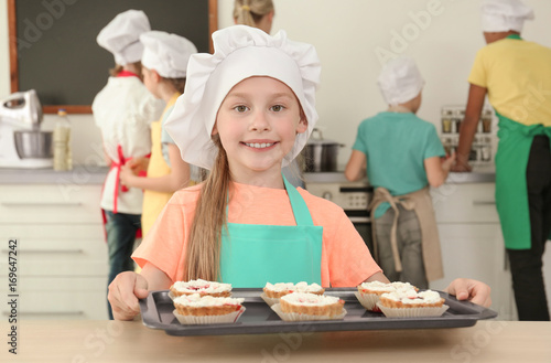 Cute girl holding tray with...