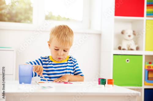 Little child drawing on the paper