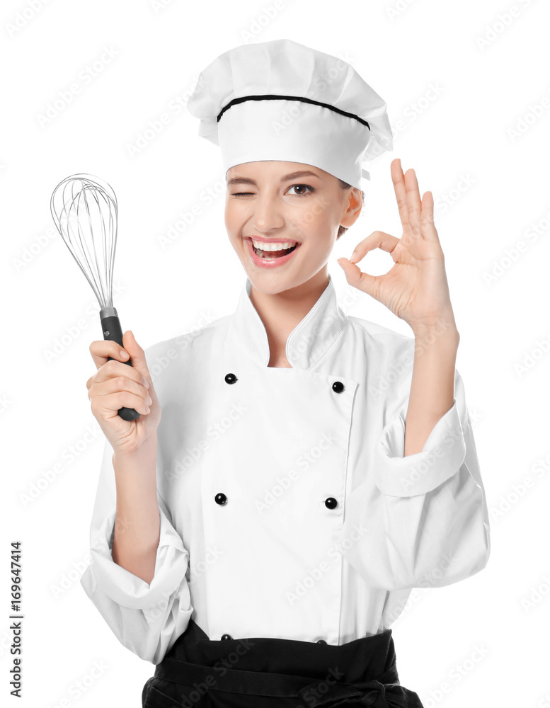 Young female chef with whisk on white background Young female chef with whisk on white background