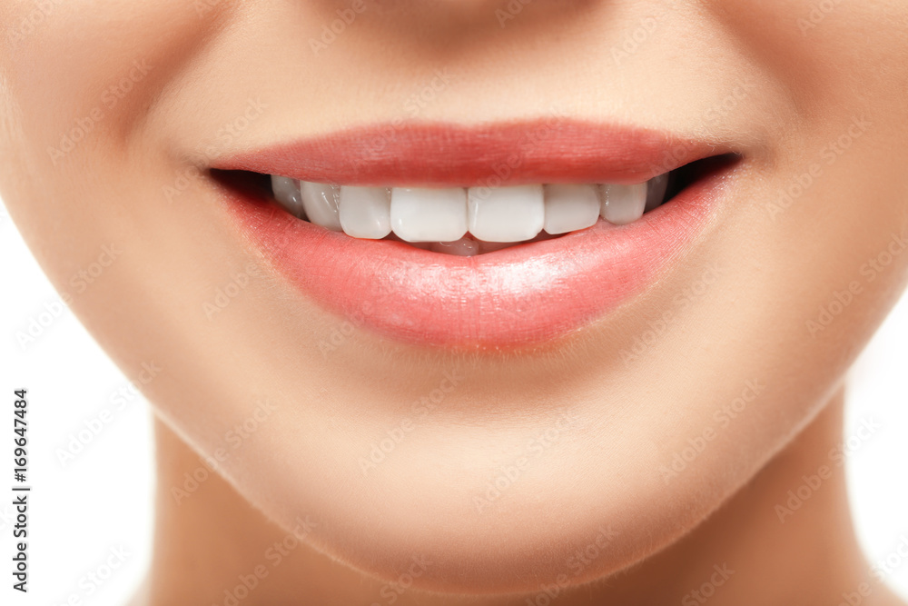 Fototapeta premium Beautiful young woman with healthy teeth on white background