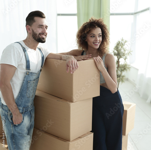 couple standing next to boxes when moving to a new house © ASDF