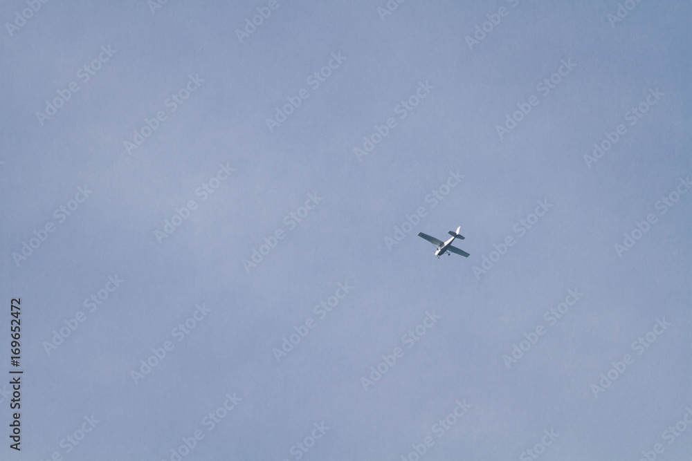 Airplane Is Flying / White Airplane Is Flying At Blue Sky Background. Airplane Is Flying / White Airplane Is Flying At Blue Sky Background.