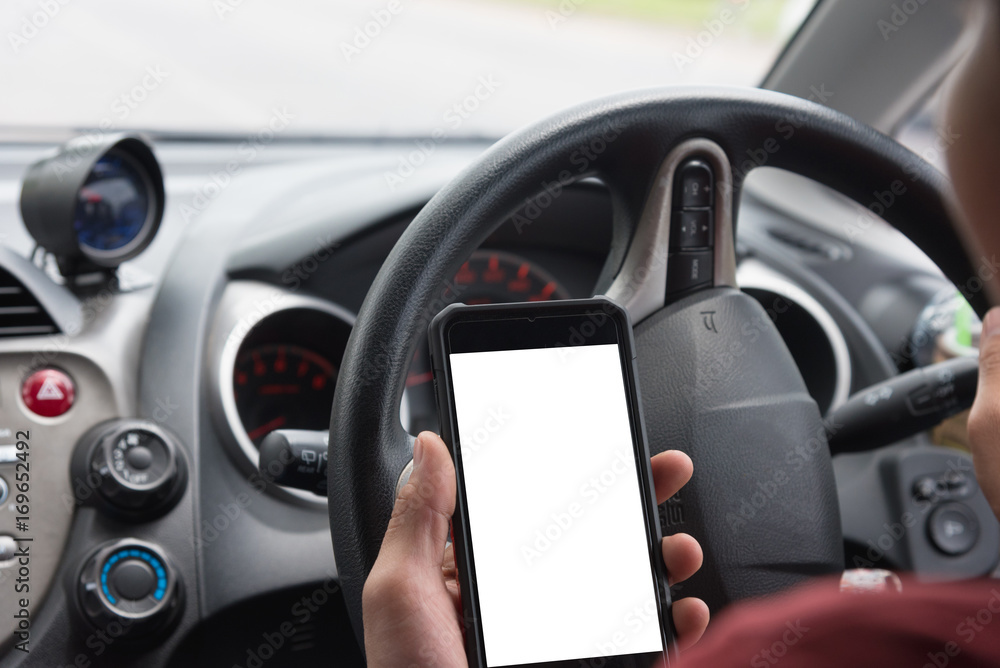 Hands playing mobile in car, concept is people playing the phone