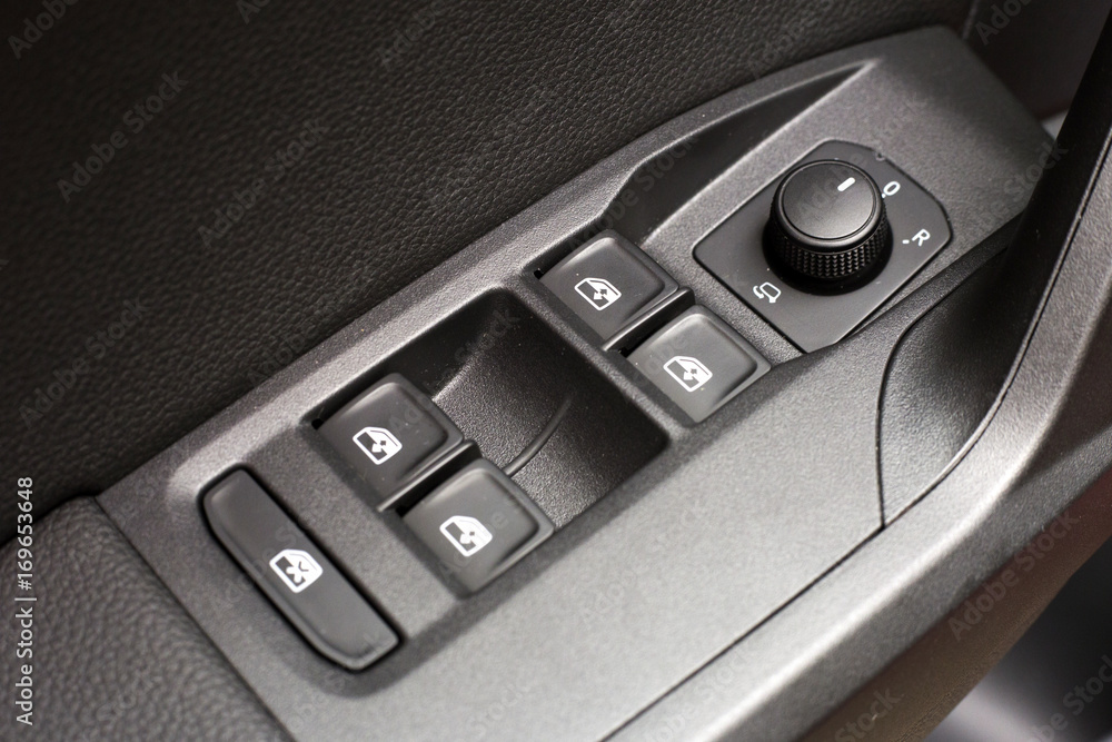 Car interior - buttons for window and rear view mirror control Car interior - buttons for window and rear view mirror control