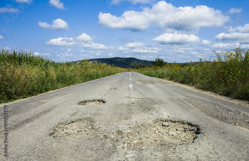 bad road cracked and damaged