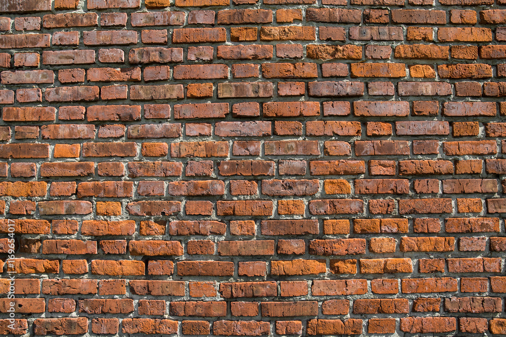 Obraz premium red brick wall texture grunge background with vignetted corners, may use to interior design