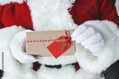 Wallpaper Mural santa claus with wrapped gift Torontodigital.ca