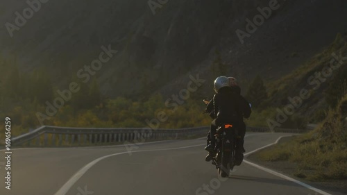Couple of Motorcyclists are Driving along a Beautiful Road in the Evening light