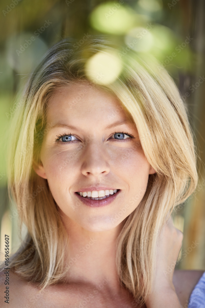 Beautiful blond woman smiling in close up