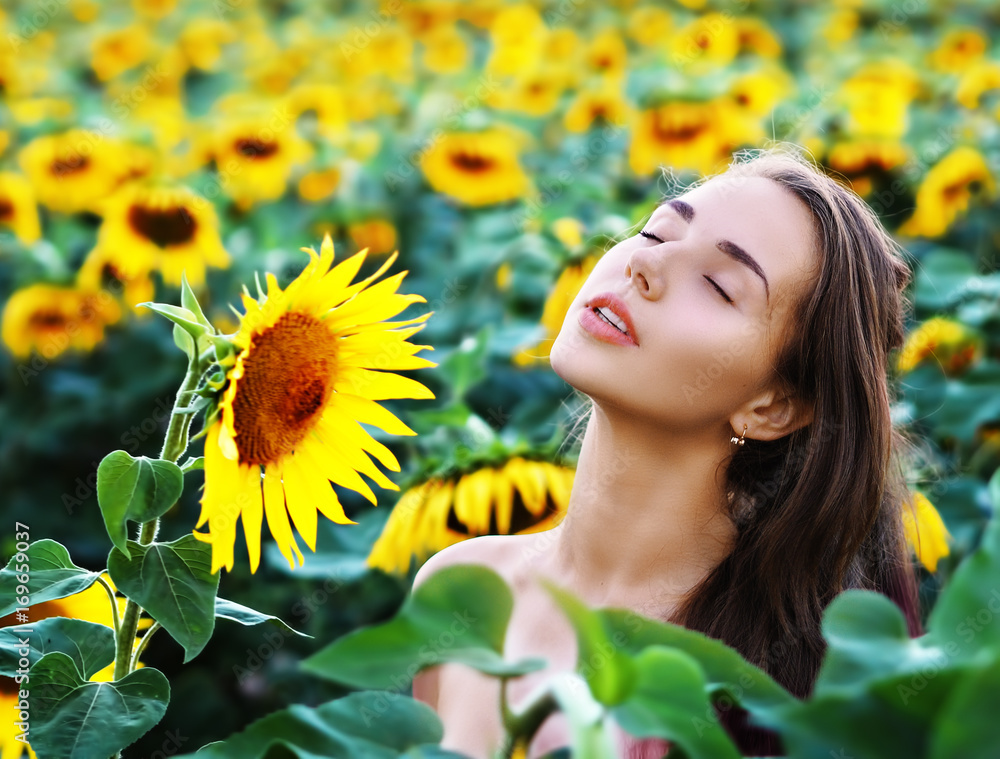 Young girl at the sunflowers portrait with closed eyes Young girl at the sunflowers portrait with closed eyes
