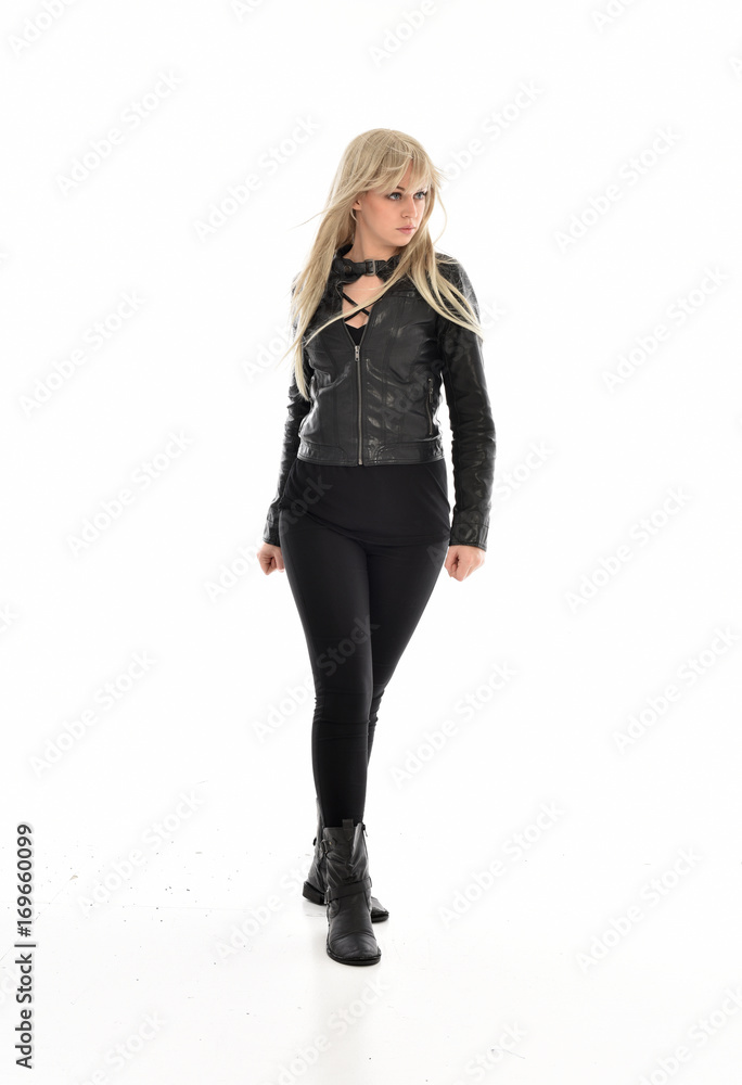 full length portrait of blonde girl wearing black leather outfit, standing pose on white background. full length portrait of blonde girl wearing black leather outfit, standing pose on white background.