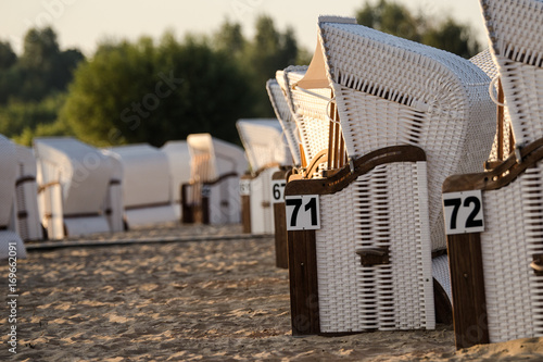 Strandkörbe bei Tagesanbruch in der Morgensonne photo