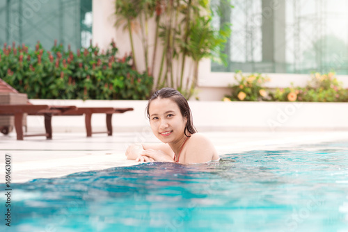 Beautiful asian woman smiling in a swimming pool © makistock