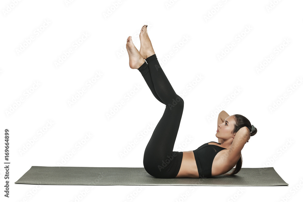 Fototapeta premium Woman exercising on yoga mat. Isolated on white.