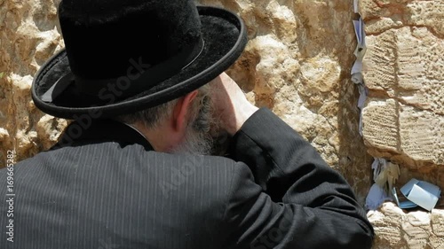 Jew haredi pray at the Western Wall also known as Wailing Wall or Kotel in Jerusalem. The Western Wall is the most sacred place for all jews and jewish in the world. photo