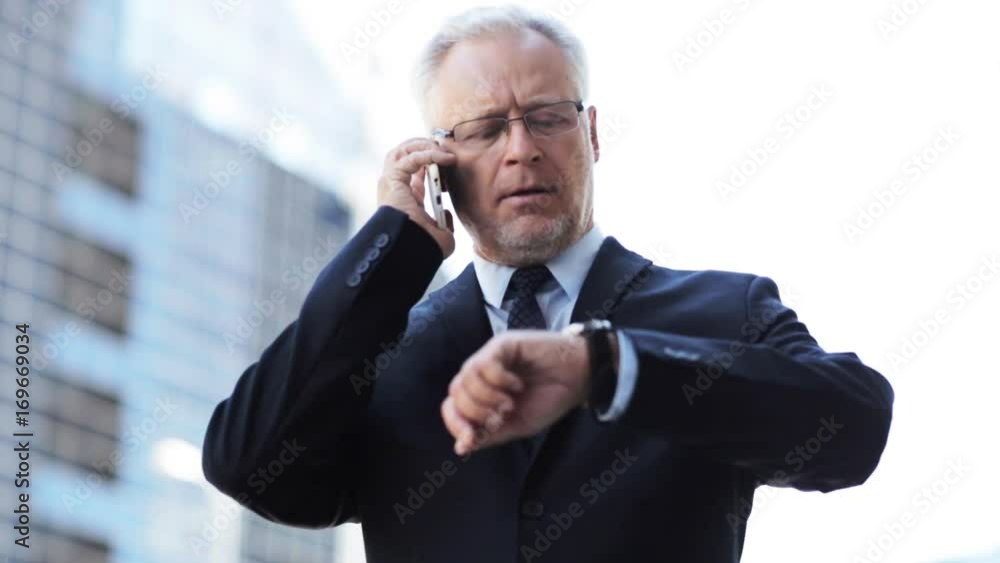 senior businessman calling on smartphone in city senior businessman calling on smartphone in city