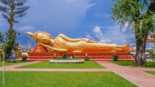 A reclining Buddha statue at Wat Pha That Luang lacated in Vientiane, Loas photo