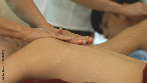 Thai Masseur preparing massage oil for couple