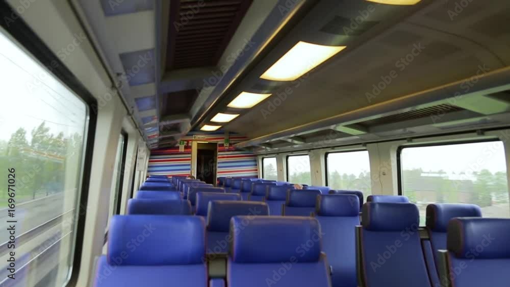 Interior of a high-speed train moving at high speed during the day in cloudy weather. Window view from fast train travelling in the Netherlands. Car of the train view from inside. Train traveling Interior of a high-speed train moving at high speed during the day in cloudy weather. Window view from fast train travelling in the Netherlands. Car of the train view from inside. Train traveling