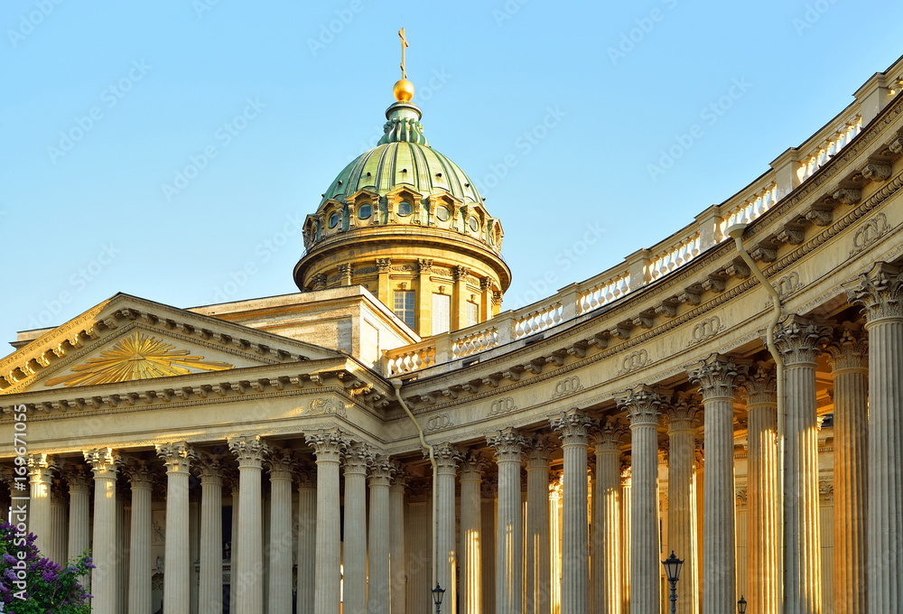 The dome and colonnade of the Kazan Cathedral lit by the sun against the sky