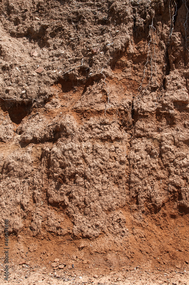 Red clay soil closeup as natural background