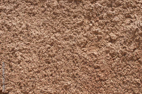 Red clay soil closeup as natural background