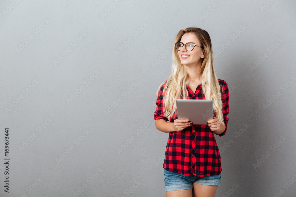 Cheerful young blonde woman chatting by tablet computer. Cheerful young blonde woman chatting by tablet computer.