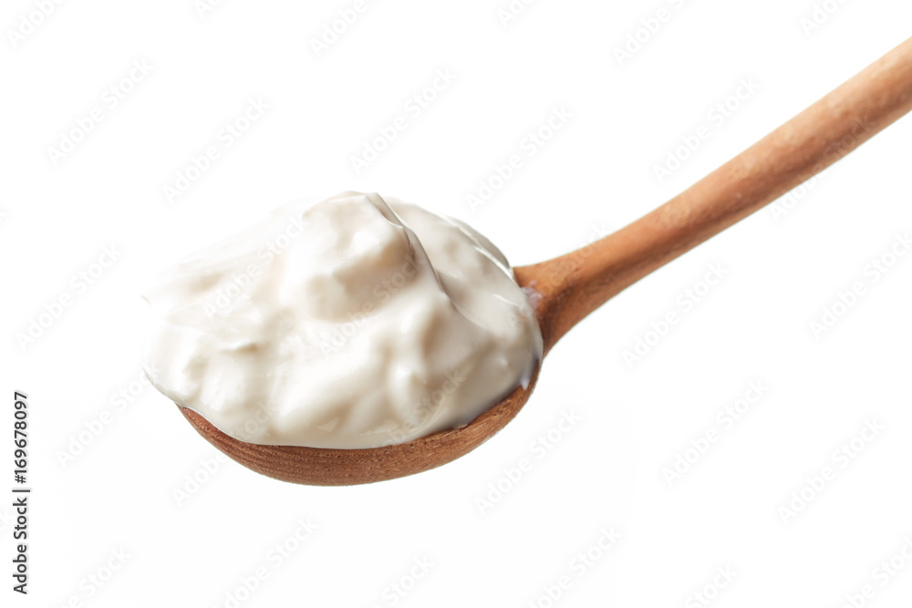 Sour cream in spoon isolated on white Sour cream in spoon isolated on white