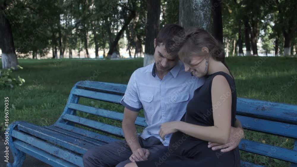 Couple in love sits on a bench Couple in love sits on a bench