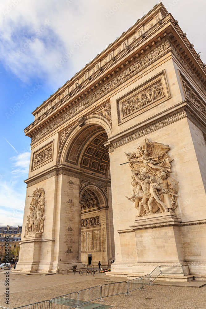 PARIS, FRANCE - DECEMBER 11, 2014: The Arc de Triomphe de l'Etoile is one of the most famous monuments, View of the Champs-Elysees Avenue is full of stores, cafes and restaurants.