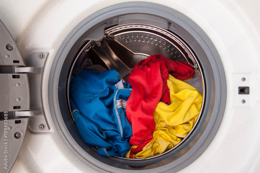 Washing machine full of dirty clothes. Washing machine full of dirty clothes.