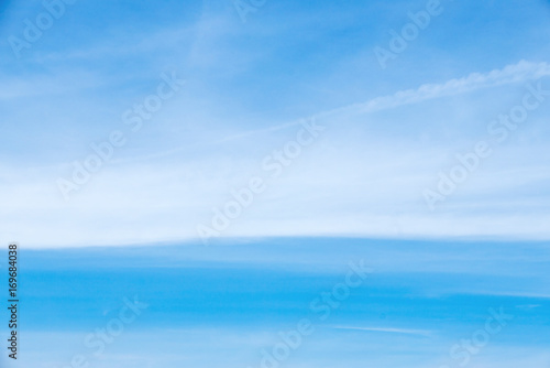 Soft white clouds against blue sky background.