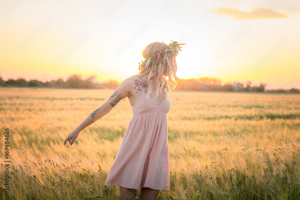 beautiful blonde lady in head flower wreath during sunrise in summer wheat fields beautiful blonde lady in head flower wreath during sunrise in summer wheat fields