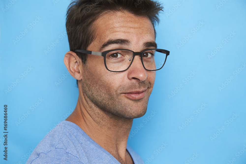 Guy in spectacles against blue background, portrait Guy in spectacles against blue background, portrait